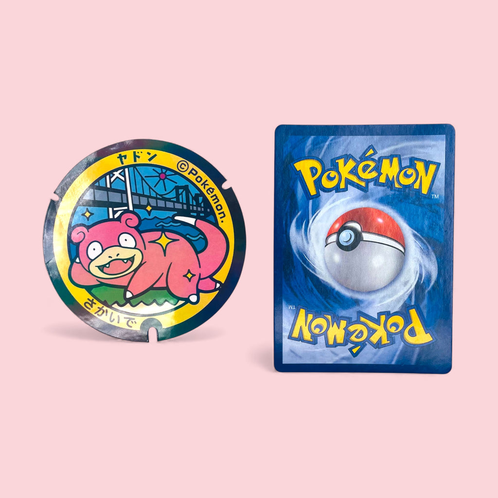 Slowpoke Poke-Lid Holographic Sticker Sakaide Japan Collectible Decor next to Pokemon card