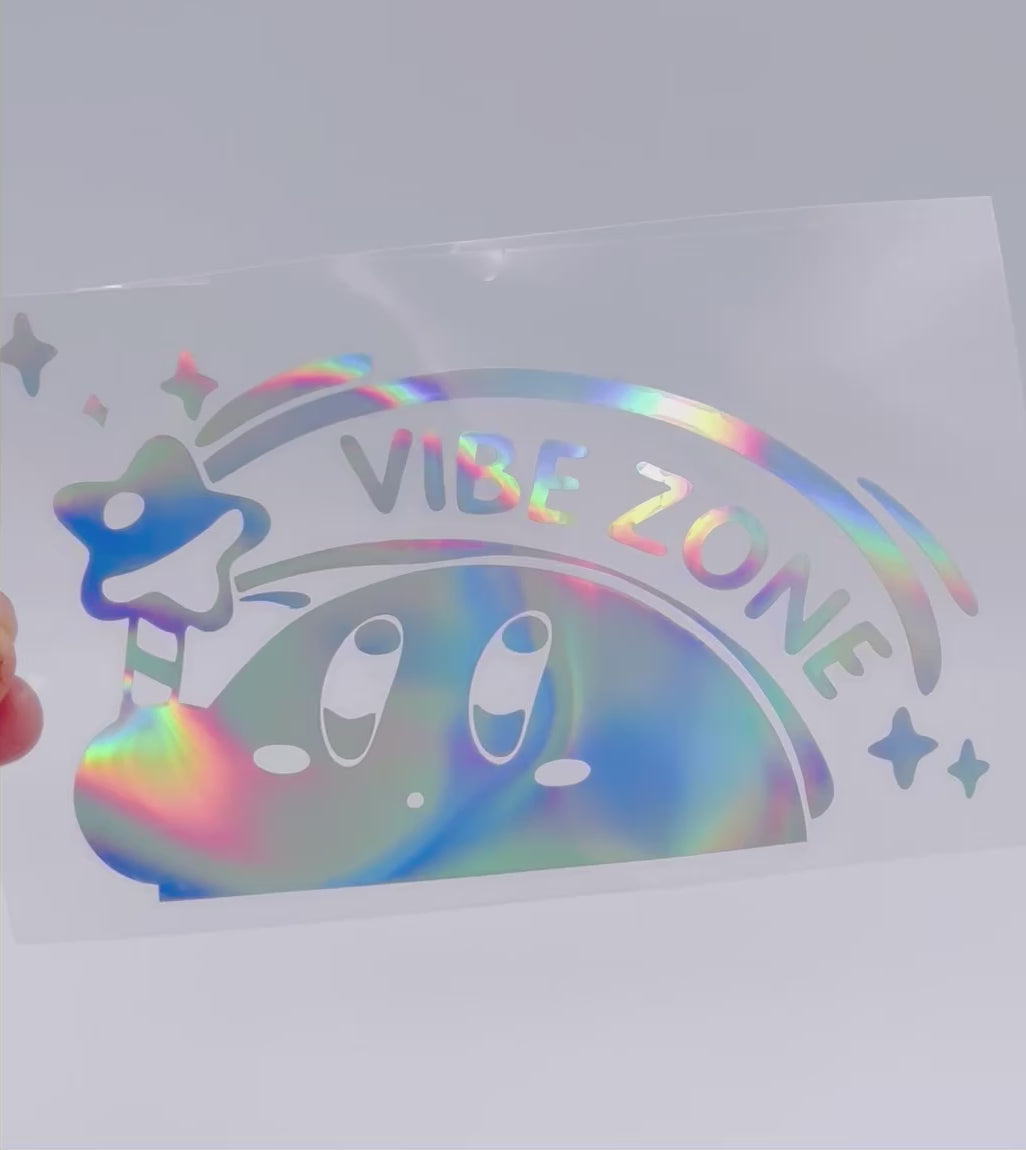 Close up of Kirby holographic vinyl decal with glossy rainbow sheen