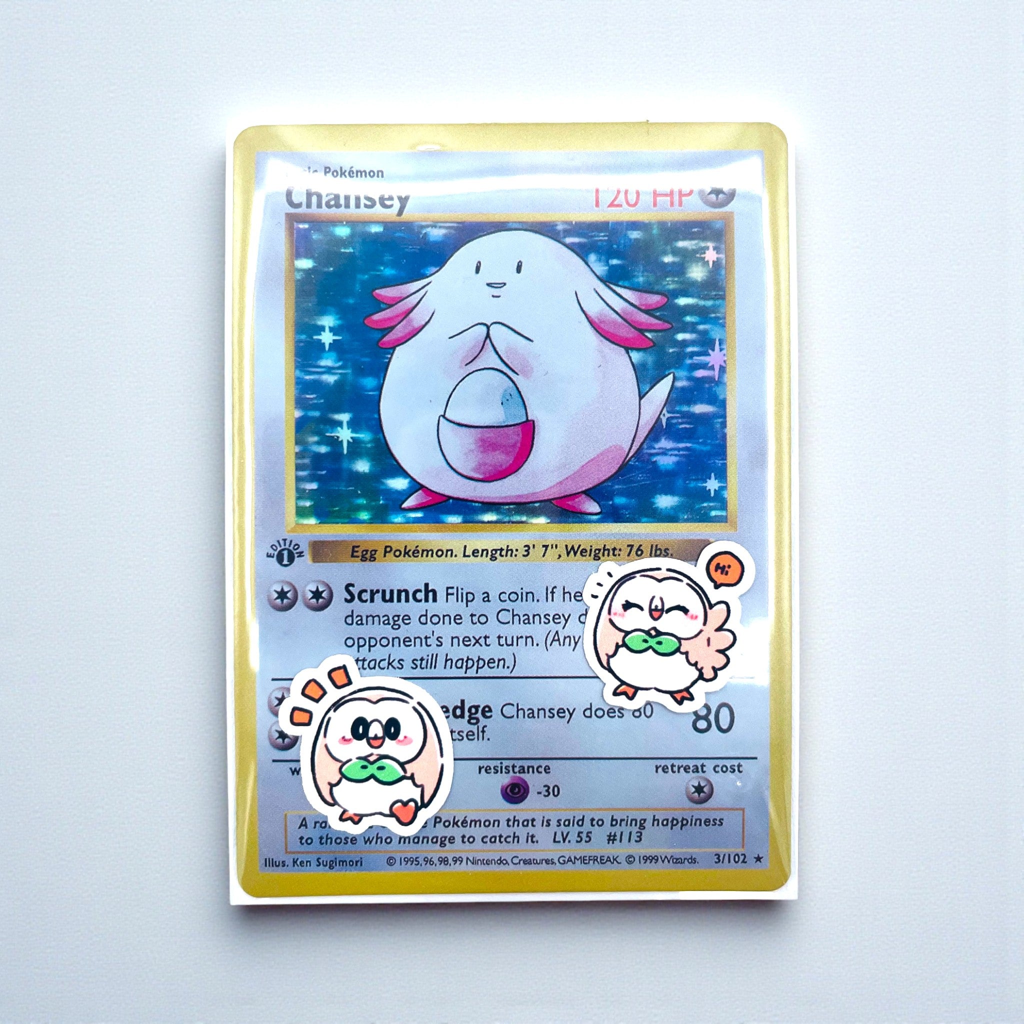 Rowlet chibi mini stickers decorating a photocard toploader